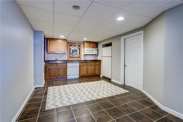1125 Shoecraft Rd, Webster, NY 14580 - kitchen featuring white appliances, dark tile patterned flooring, dark countertops, brown cabinetry, and a paneled ceiling