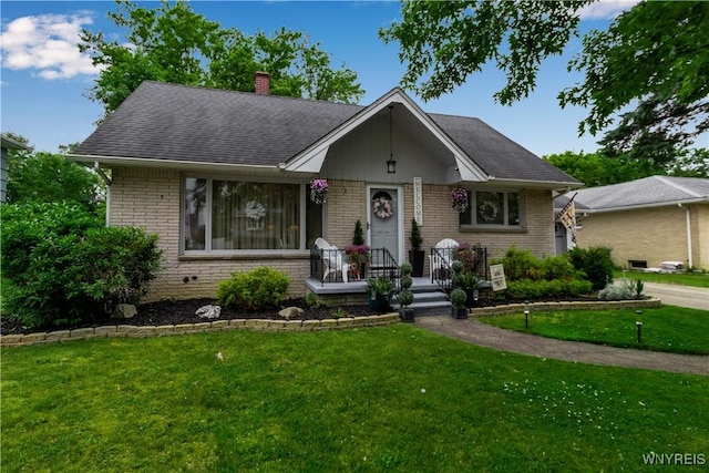 204 French Lea Rd, West Seneca, NY 14224 - view of front of property featuring brick siding, a front yard, a chimney, and a shingled roof