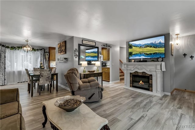 204 French Lea Rd, West Seneca, NY 14224 - living area featuring a chandelier, light wood-type flooring, and a glass covered fireplace