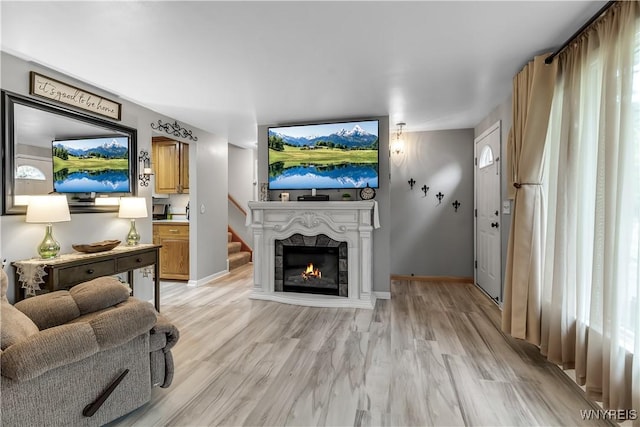 204 French Lea Rd, West Seneca, NY 14224 - living room featuring light wood finished floors and a lit fireplace