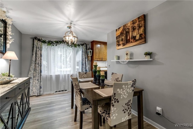 204 French Lea Rd, West Seneca, NY 14224 - dining room featuring a chandelier and light wood-style floors