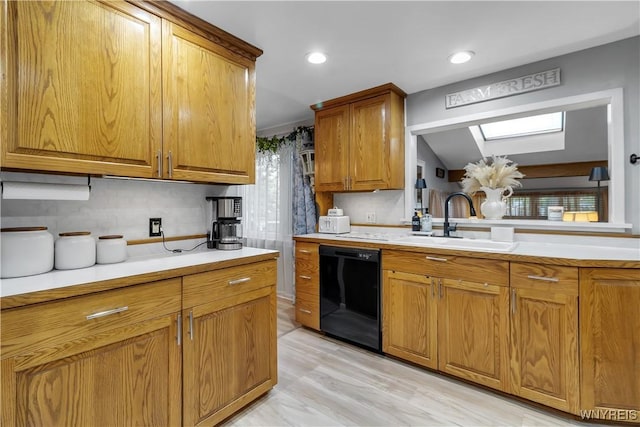 204 French Lea Rd, West Seneca, NY 14224 - kitchen with black dishwasher, a skylight, brown cabinets, light countertops, and recessed lighting