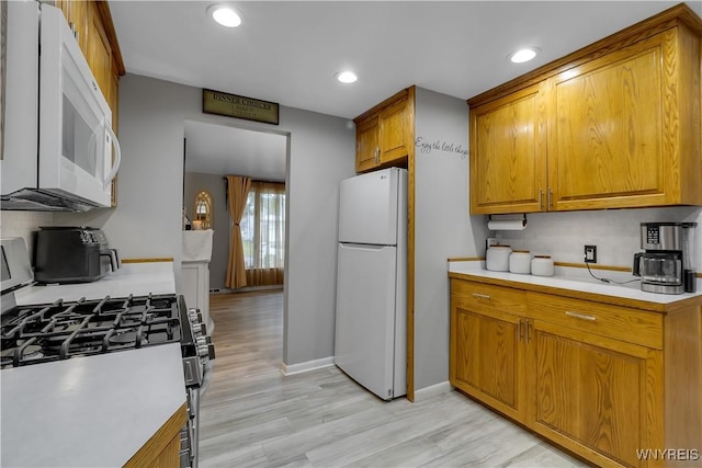 204 French Lea Rd, West Seneca, NY 14224 - kitchen with white appliances, brown cabinets, light countertops, recessed lighting, and light wood-type flooring