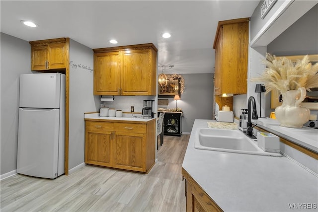 204 French Lea Rd, West Seneca, NY 14224 - kitchen with freestanding refrigerator, brown cabinets, light wood-style flooring, light countertops, and recessed lighting