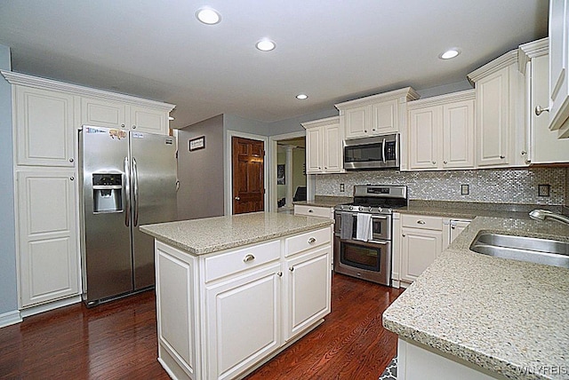 47 Timber Cove Ct, Amherst, NY 14051 - kitchen with appliances with stainless steel finishes, dark wood-style flooring, tasteful backsplash, a kitchen island, and recessed lighting