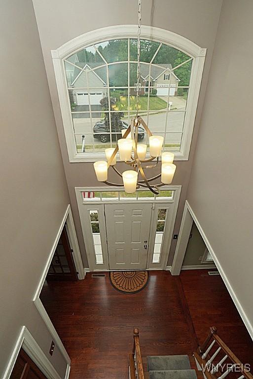 47 Timber Cove Ct, Amherst, NY 14051 - entryway with a high ceiling, wood finished floors, and a chandelier