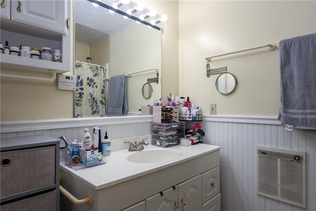 477 Pine Circle Ext, Big Flats, NY 14845 - bathroom featuring heating unit, wainscoting, vanity, and a shower with shower curtain