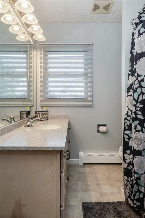 477 Pine Circle Ext, Big Flats, NY 14845 - full bath with baseboard heating, vanity, healthy amount of natural light, and tile patterned floors
