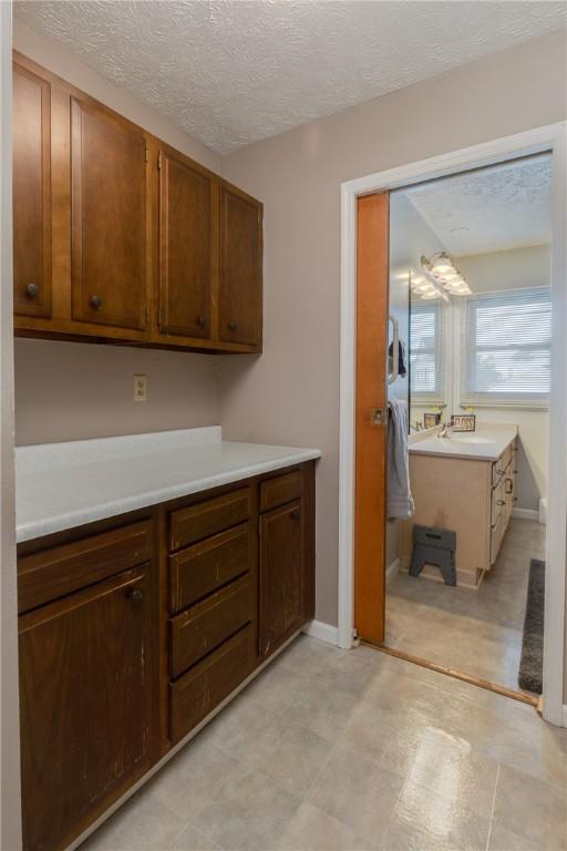 477 Pine Circle Ext, Big Flats, NY 14845 - kitchen with light countertops, a textured ceiling, and light flooring
