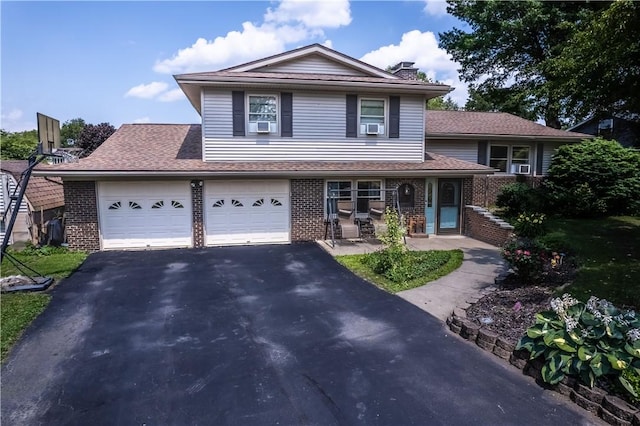 477 Pine Circle Ext, Big Flats, NY 14845 - split level home featuring brick siding, asphalt driveway, a chimney, and a porch