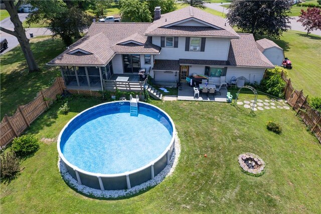477 Pine Circle Ext, Big Flats, NY 14845 - rear view of house with a fenced backyard, a patio, a sunroom, outdoor lounge area, and a shingled roof