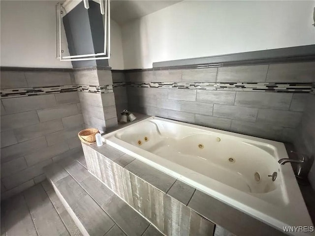 7 High St, Lyons, NY 14489 - full bathroom with tile walls, a whirlpool tub, and a wainscoted wall