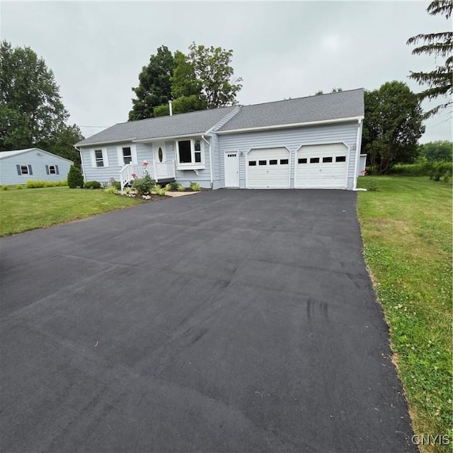 5709 Merry St, Verona, NY 13478 - view of front of house featuring an attached garage, a front yard, and driveway