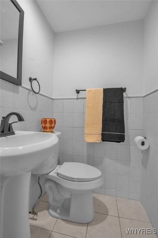 849 Delaware Ave Unit 404, Buffalo, NY 14209 - half bath featuring tile walls, tile patterned floors, and wainscoting