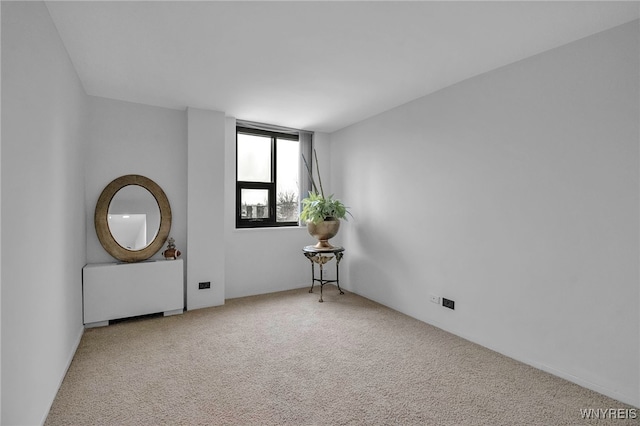 849 Delaware Ave Unit 404, Buffalo, NY 14209 - spare room featuring carpet and radiator