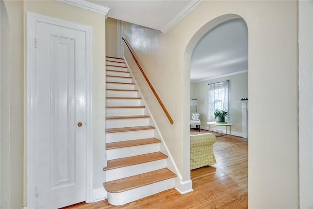 772 Winona Blvd, Irondequoit, NY 14617 - stairs featuring crown molding, arched walkways, and wood finished floors