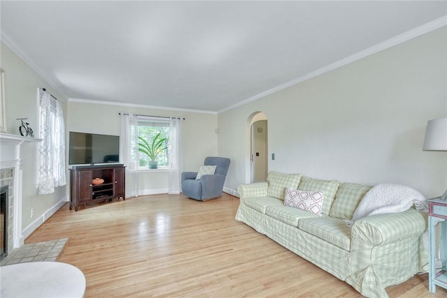 772 Winona Blvd, Irondequoit, NY 14617 - living area with arched walkways, light wood-style floors, a tile fireplace, and crown molding