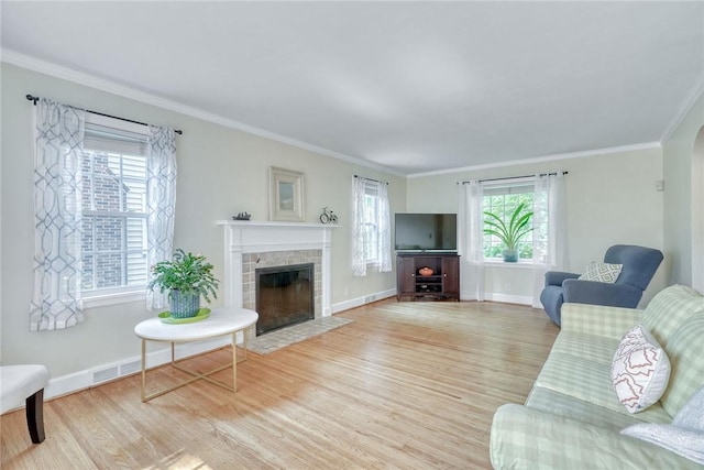 772 Winona Blvd, Irondequoit, NY 14617 - living area with wood finished floors, crown molding, and a tiled fireplace