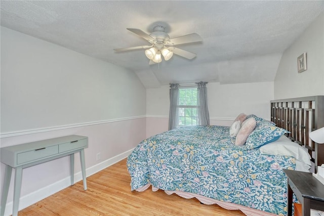 772 Winona Blvd, Irondequoit, NY 14617 - bedroom with vaulted ceiling, wood finished floors, ceiling fan, and a textured ceiling