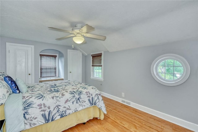772 Winona Blvd, Irondequoit, NY 14617 - bedroom with multiple windows, wood finished floors, vaulted ceiling, and ceiling fan