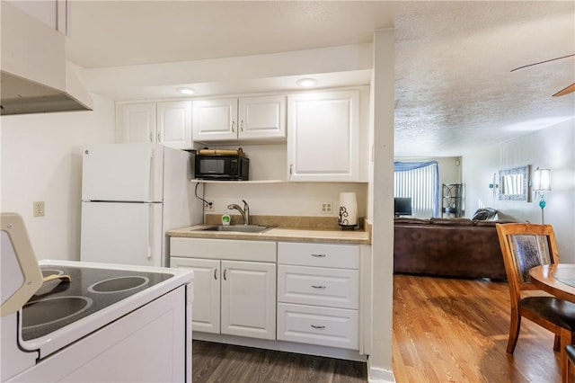 80 Autumn Chapel Way, Chili, NY 14624 - kitchen with white appliances, dark wood-type flooring, under cabinet range hood, white cabinets, and light countertops