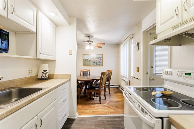 80 Autumn Chapel Way, Chili, NY 14624 - kitchen featuring white electric range, under cabinet range hood, dark wood-style floors, white cabinetry, and a ceiling fan