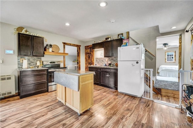 2890 Eagles Nest Rd, Yorkshire, NY 14042 - kitchen with freestanding refrigerator, electric range, light wood finished floors, tasteful backsplash, and recessed lighting