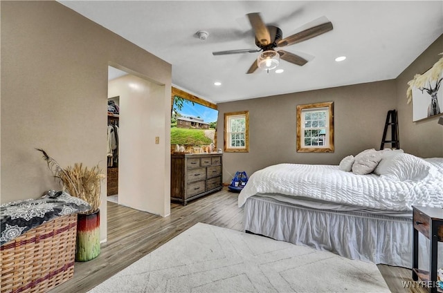 2890 Eagles Nest Rd, Yorkshire, NY 14042 - bedroom featuring wood finished floors, recessed lighting, a spacious closet, and a ceiling fan
