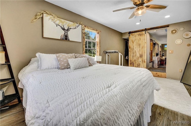 2890 Eagles Nest Rd, Yorkshire, NY 14042 - bedroom featuring a barn door, wood finished floors, recessed lighting, and a ceiling fan