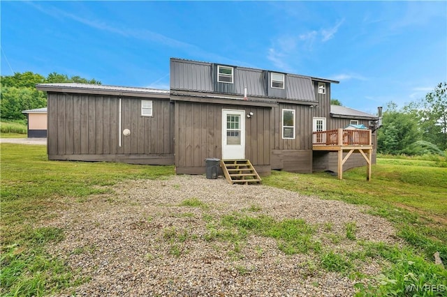 2890 Eagles Nest Rd, Yorkshire, NY 14042 - back of house featuring a deck, board and batten siding, a metal roof, and a yard