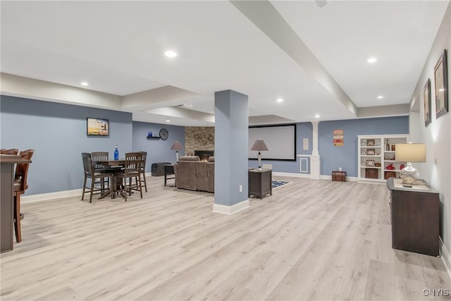 21 Donovan Dr, Oswego, NY 13126 - living area with light wood-style floors, a stone fireplace, recessed lighting, and built in features