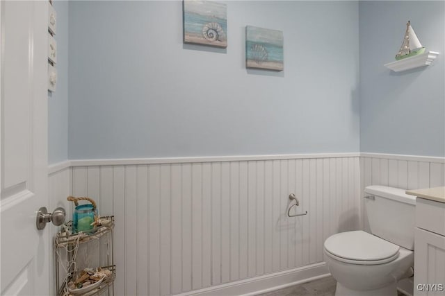 21 Donovan Dr, Oswego, NY 13126 - bathroom featuring a wainscoted wall, wood finished floors, and vanity