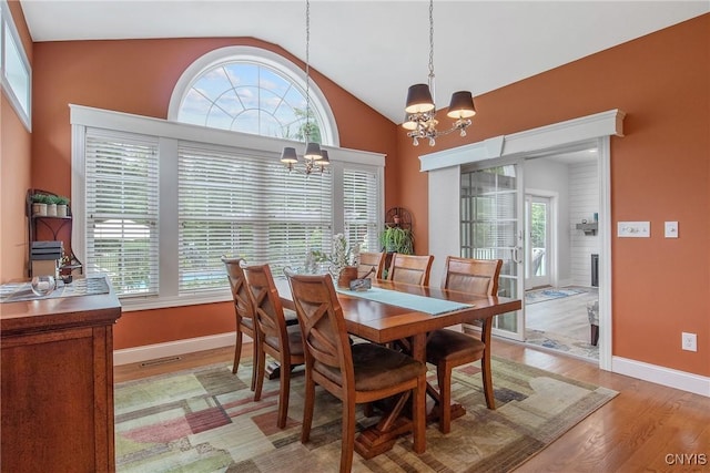 21 Donovan Dr, Oswego, NY 13126 - dining room featuring a chandelier, plenty of natural light, light wood finished floors, and lofted ceiling