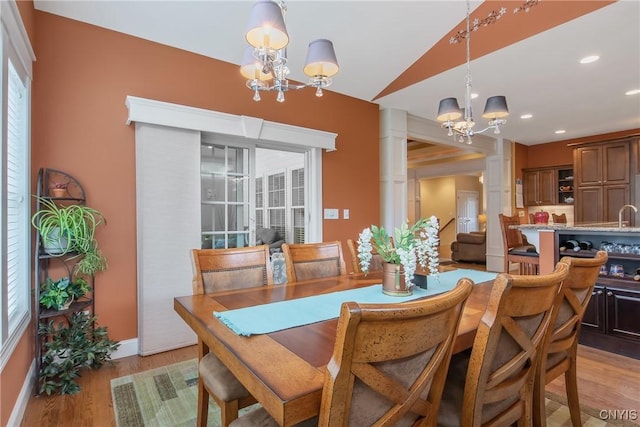 21 Donovan Dr, Oswego, NY 13126 - dining space with a chandelier, light wood-style floors, and vaulted ceiling