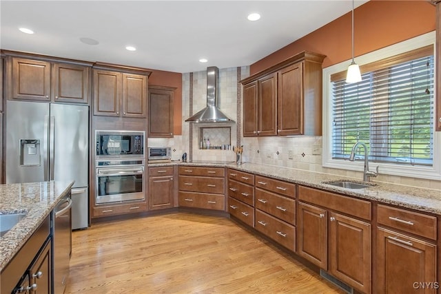 21 Donovan Dr, Oswego, NY 13126 - kitchen with stainless steel appliances, wall chimney exhaust hood, decorative backsplash, hanging light fixtures, and recessed lighting
