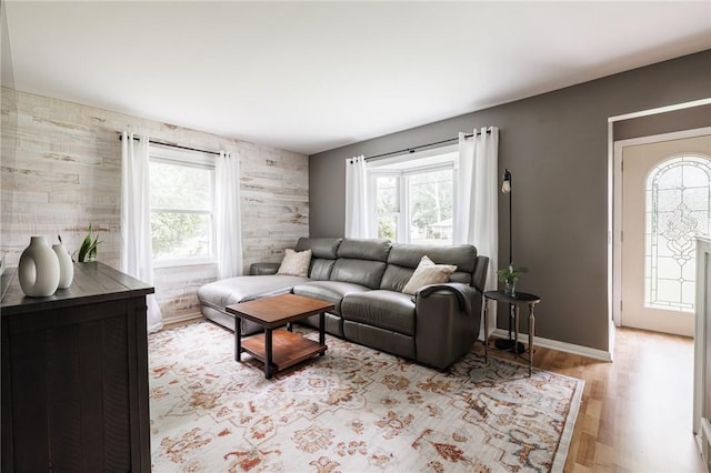 263 Volk Rd, Webster, NY 14580 - living area with healthy amount of natural light, an accent wall, and wood finished floors