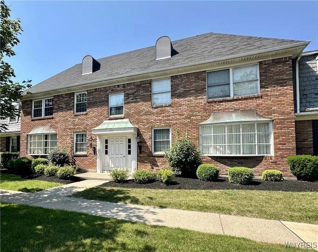 1330 Maple Rd Unit 4, Amherst, NY 14221 - georgian-style home with brick siding, a front lawn, and roof with shingles