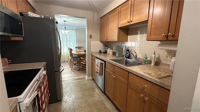 1330 Maple Rd Unit 4, Amherst, NY 14221 - kitchen with appliances with stainless steel finishes, brown cabinets, and backsplash