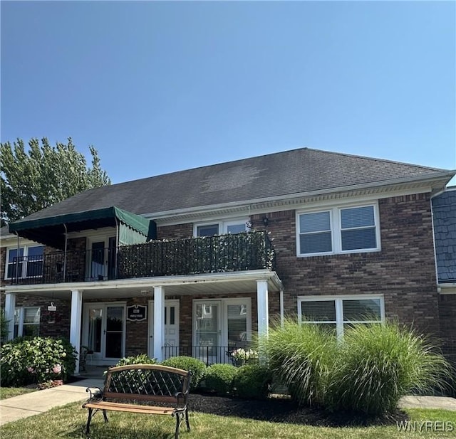 1330 Maple Rd Unit 4, Amherst, NY 14221 - rear view of house featuring a balcony, brick siding, and covered porch