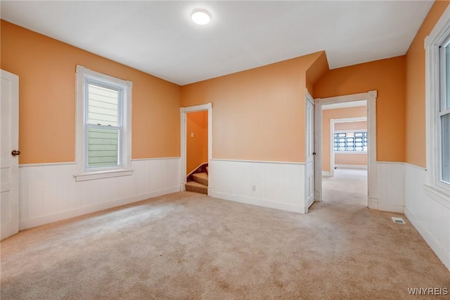 285 E N St Unit S, Buffalo, NY 14204 - spare room featuring wainscoting, carpet flooring, and stairs