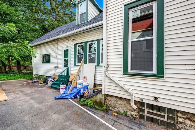 285 E N St Unit S, Buffalo, NY 14204 - view of side of property with entry steps, a shingled roof, and a patio area