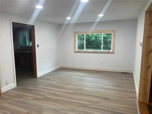 33 E Vanscoter St, Hornell, NY 14843 - unfurnished room with baseboards and light wood-style flooring