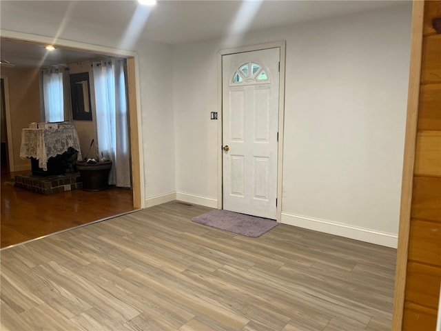 33 E Vanscoter St, Hornell, NY 14843 - entryway featuring wood finished floors and a wood stove