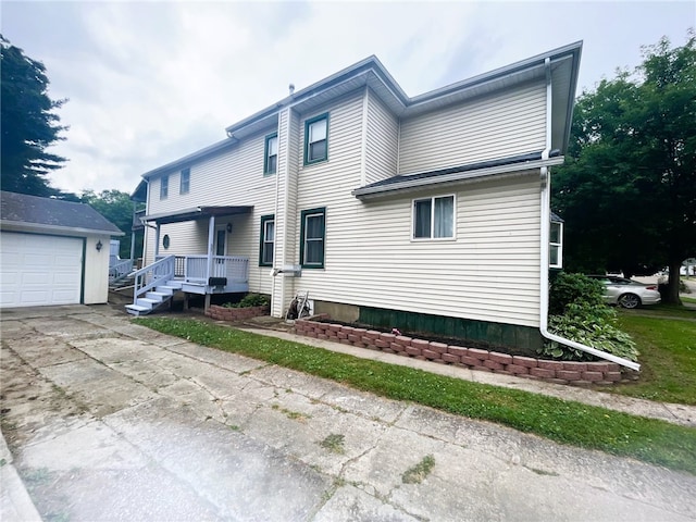 33 E Vanscoter St, Hornell, NY 14843 - view of front facade featuring an outbuilding, a garage, and driveway