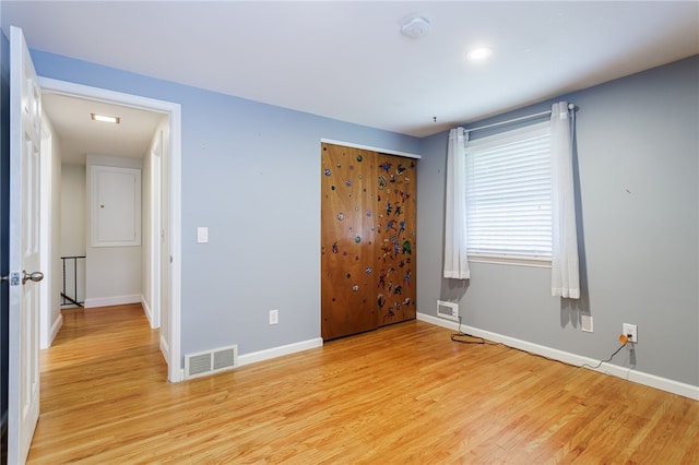 32 White Birch Cir, Chili, NY 14624 - unfurnished bedroom featuring light wood-style floors and a closet