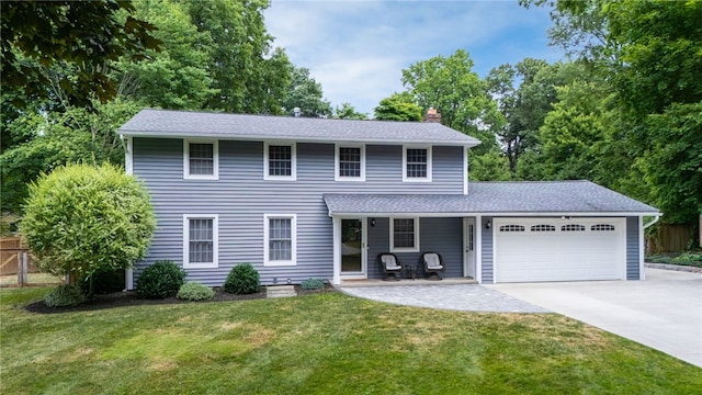 32 White Birch Cir, Chili, NY 14624 - colonial home with a chimney, an attached garage, concrete driveway, and a shingled roof