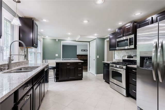 32 White Birch Cir, Chili, NY 14624 - kitchen with appliances with stainless steel finishes, ornamental molding, tasteful backsplash, light stone counters, and light tile patterned flooring