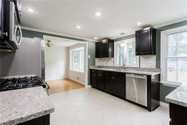 32 White Birch Cir, Chili, NY 14624 - kitchen with stainless steel appliances, crown molding, dark cabinets, healthy amount of natural light, and decorative backsplash