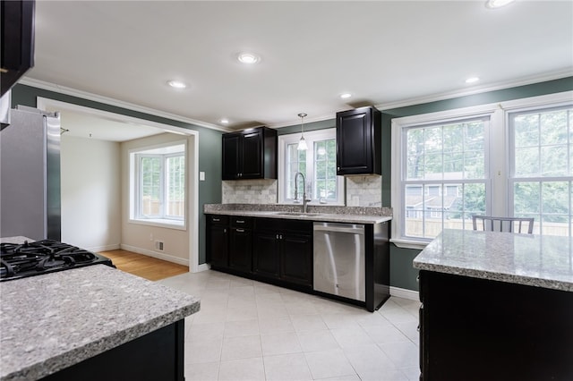 32 White Birch Cir, Chili, NY 14624 - kitchen with stainless steel appliances, dark cabinetry, ornamental molding, tasteful backsplash, and light stone counters