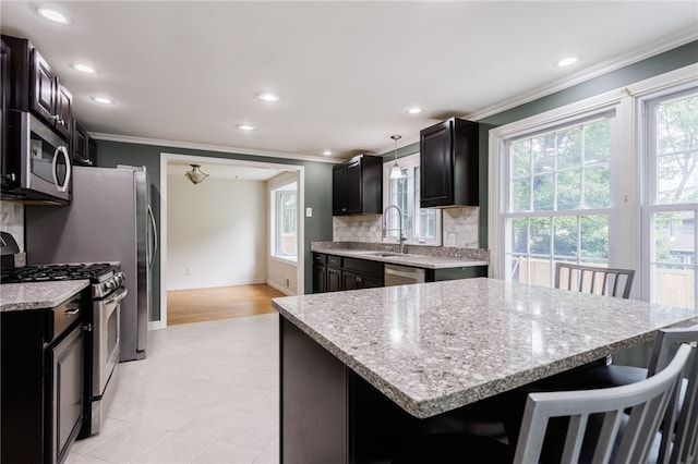 32 White Birch Cir, Chili, NY 14624 - kitchen featuring stainless steel appliances, ornamental molding, tasteful backsplash, recessed lighting, and light stone counters